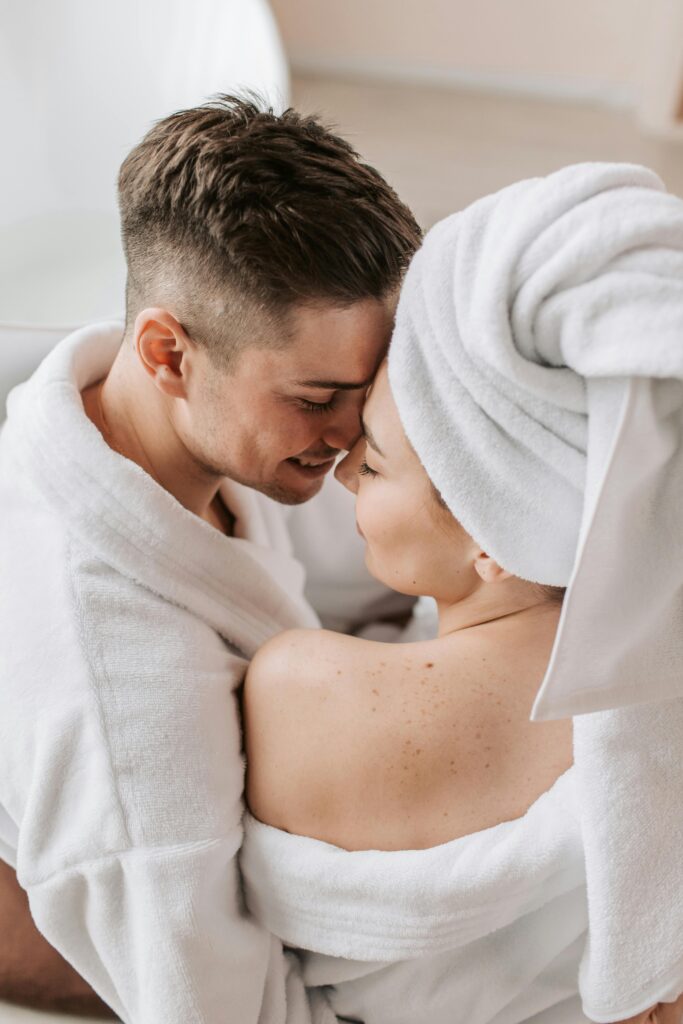 Close-up of a loving couple in bathrobes sharing an intimate moment indoors.